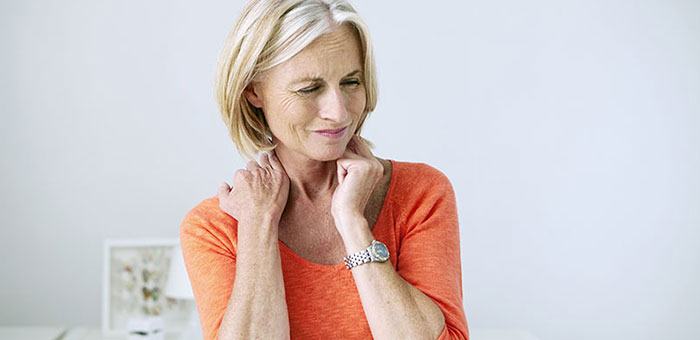 Mature woman suffering from neck and shoulder pain before visiting Minnetonka chiropractor