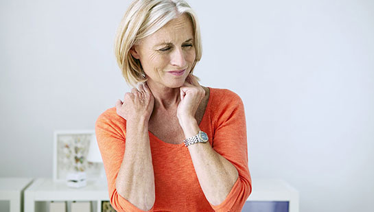 Mature woman suffering from neck and shoulder pain before visiting Minnetonka chiropractor