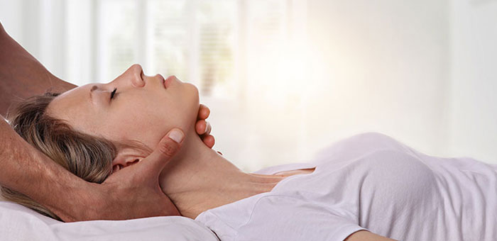 Woman receiving neck adjustment from Minnetonka chiropractor