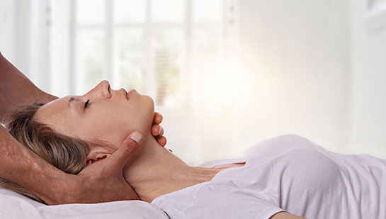 Woman receiving neck adjustment from Minnetonka chiropractor